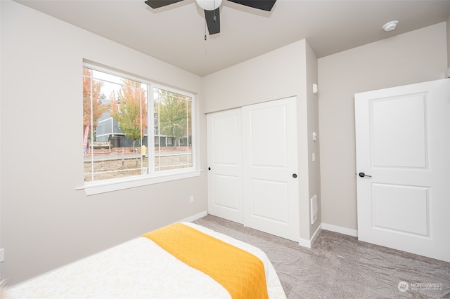 bedroom with carpet flooring, ceiling fan, and a closet