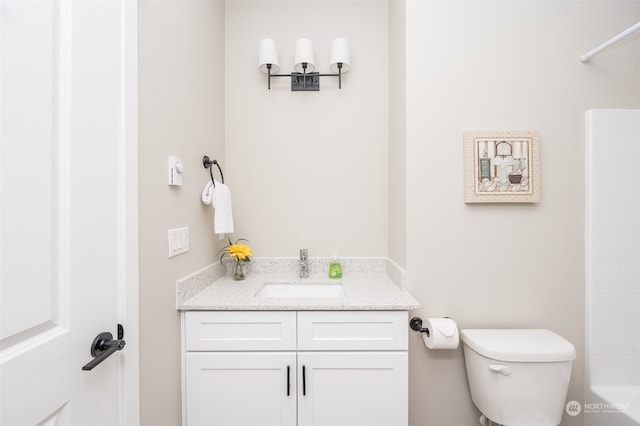 full bathroom featuring shower / bathing tub combination, vanity, and toilet