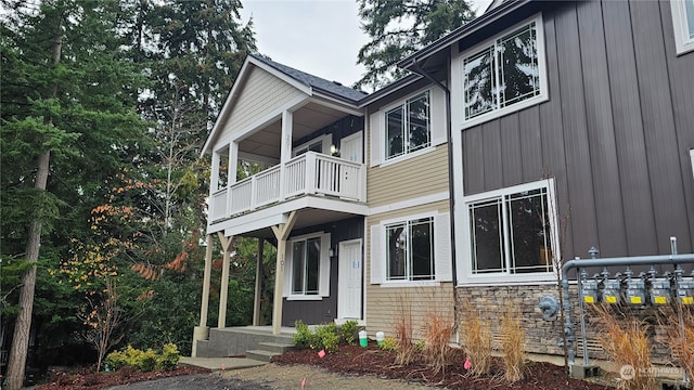 view of side of home featuring a balcony