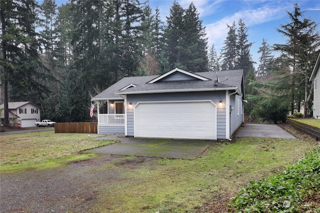 view of front of property with covered porch, a garage, and a front lawn