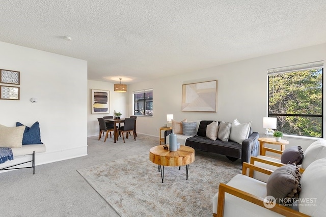 carpeted living room featuring a textured ceiling