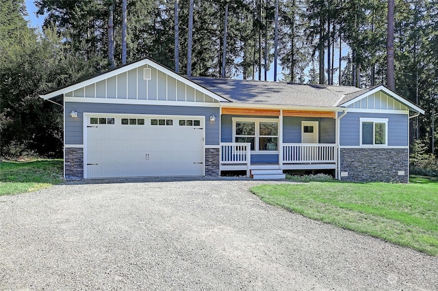 craftsman house with a garage, a front lawn, and a porch