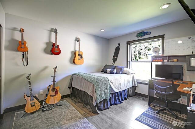 bedroom with wood-type flooring