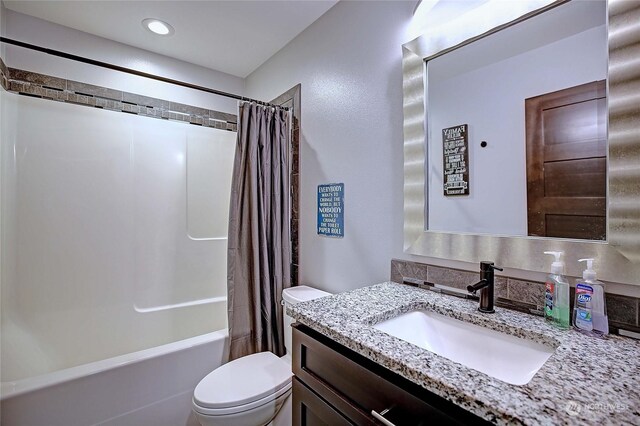 full bathroom with shower / tub combo, vanity, and toilet