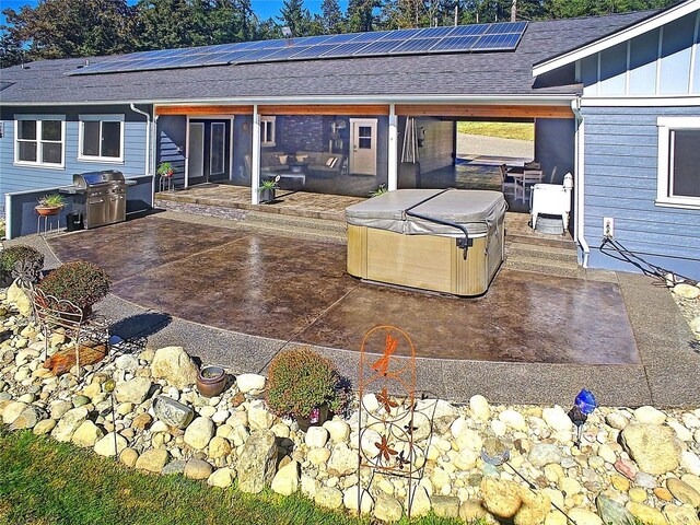 view of patio / terrace featuring a hot tub and a grill