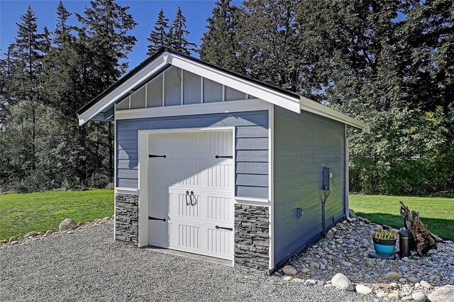 view of outbuilding featuring a yard and a garage