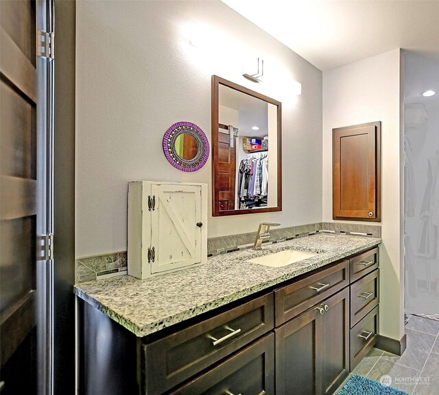 bathroom featuring tile patterned flooring and vanity