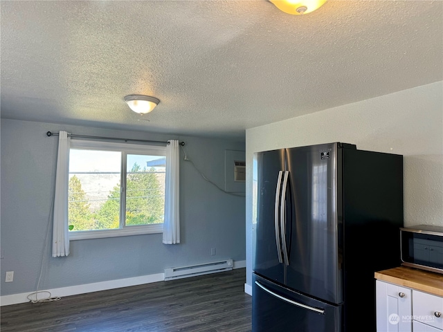 kitchen with stainless steel fridge, dark wood-type flooring, a textured ceiling, a baseboard radiator, and wood counters