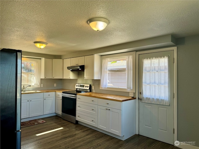 kitchen with butcher block countertops, white cabinets, stainless steel range with electric stovetop, and black refrigerator