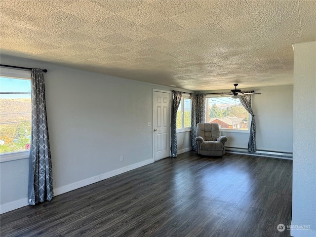 interior space with a textured ceiling, dark hardwood / wood-style flooring, ceiling fan, and a baseboard radiator