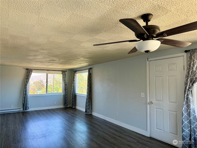 interior space featuring ceiling fan, a textured ceiling, baseboard heating, and dark hardwood / wood-style flooring