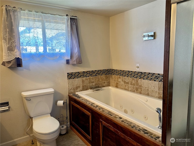 bathroom featuring a washtub, toilet, and tile patterned floors