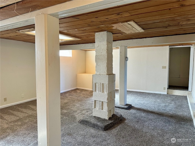 basement featuring wood ceiling and carpet flooring