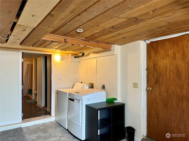 clothes washing area featuring wooden ceiling and independent washer and dryer