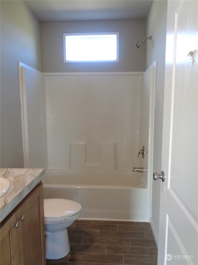 full bathroom featuring wood-type flooring, tub / shower combination, vanity, and toilet