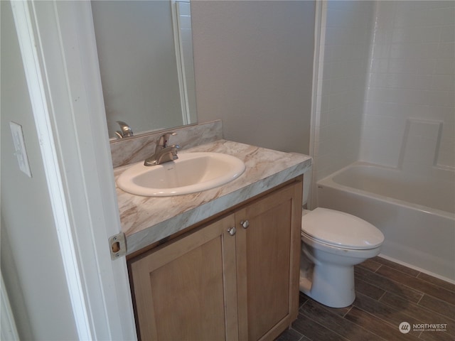 full bathroom with bathing tub / shower combination, vanity, and toilet