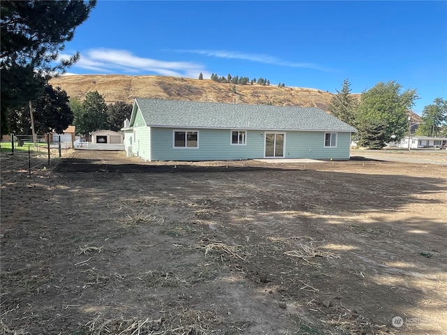 back of house featuring a mountain view