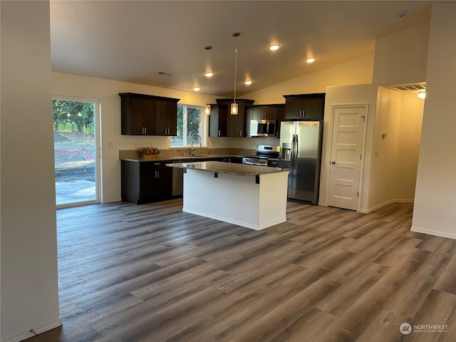 kitchen featuring a kitchen island, dark wood-type flooring, stainless steel appliances, dark brown cabinets, and a sink