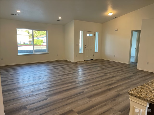 foyer entrance with baseboards, visible vents, lofted ceiling, dark wood-style floors, and recessed lighting