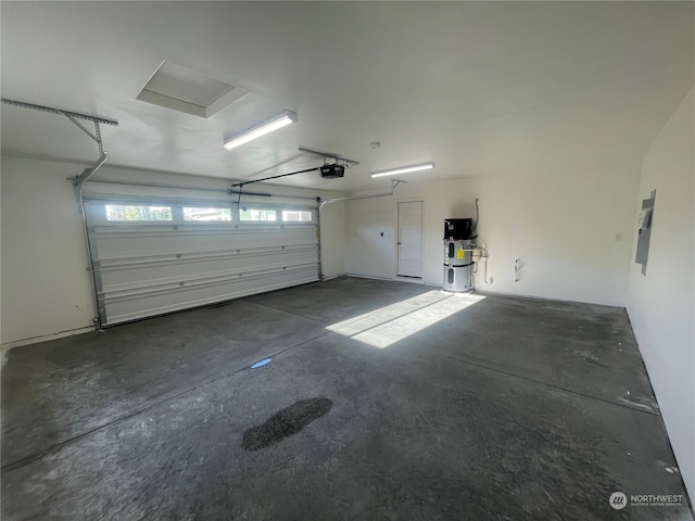 garage with a garage door opener and electric panel