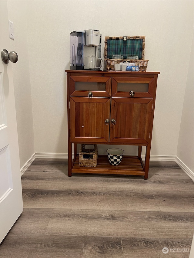 room details featuring baseboards and wood finished floors