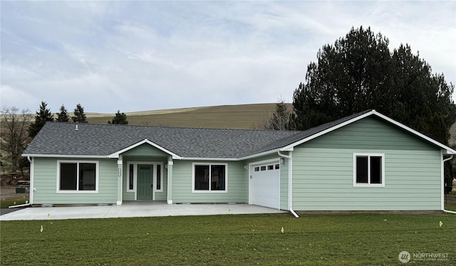 ranch-style house with a garage, a front lawn, and roof with shingles