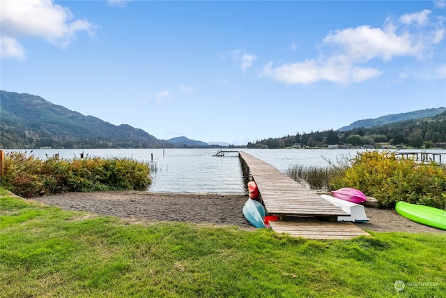 view of dock featuring a water and mountain view