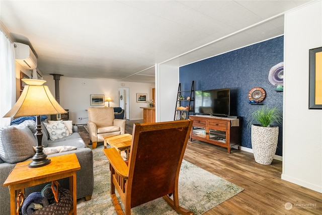 living room with wood-type flooring and an AC wall unit