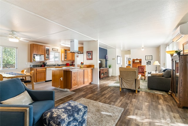 living room with dark hardwood / wood-style flooring, ceiling fan, and sink