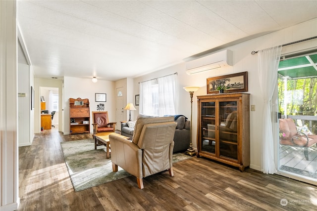 living room featuring a textured ceiling, dark hardwood / wood-style floors, and an AC wall unit