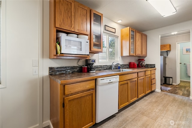 kitchen featuring white appliances and sink