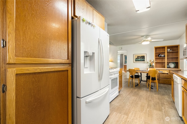 kitchen featuring light hardwood / wood-style flooring, white appliances, and ceiling fan