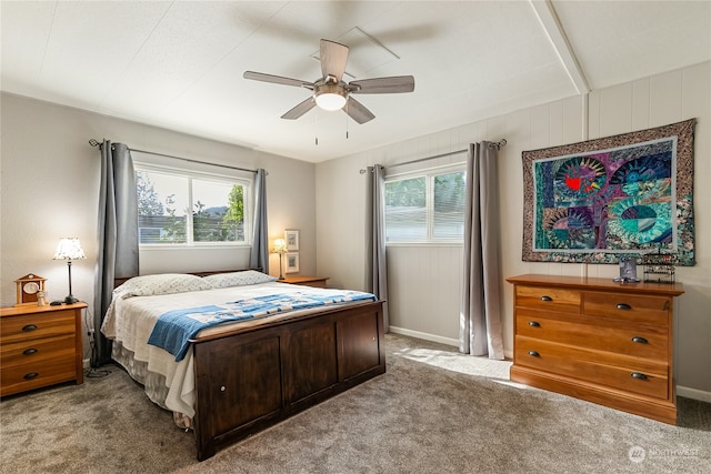 carpeted bedroom with multiple windows and ceiling fan