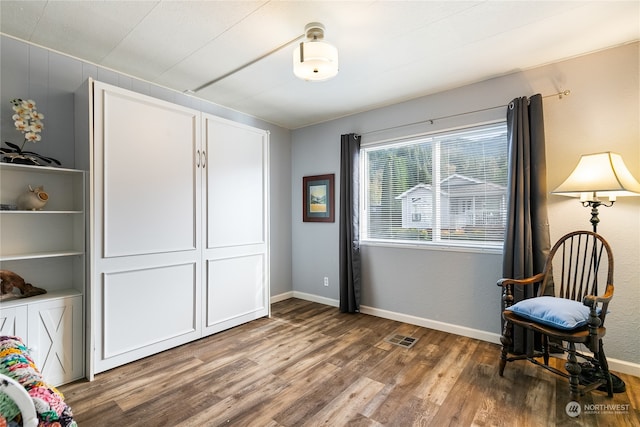 living area with hardwood / wood-style flooring