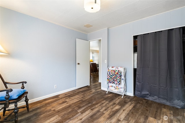 living area with ornamental molding and dark hardwood / wood-style floors