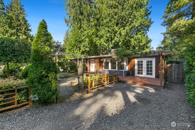 rear view of house with a deck and french doors