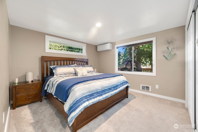 carpeted bedroom with a wall mounted AC