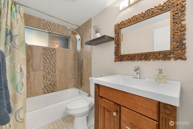 full bathroom featuring vanity, shower / bath combo with shower curtain, and toilet