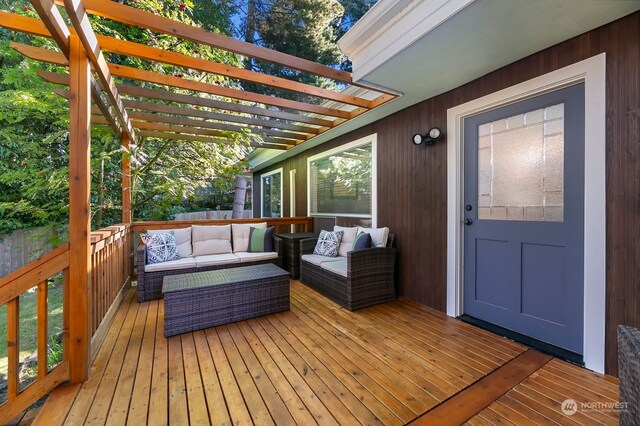 wooden deck featuring a pergola and an outdoor living space