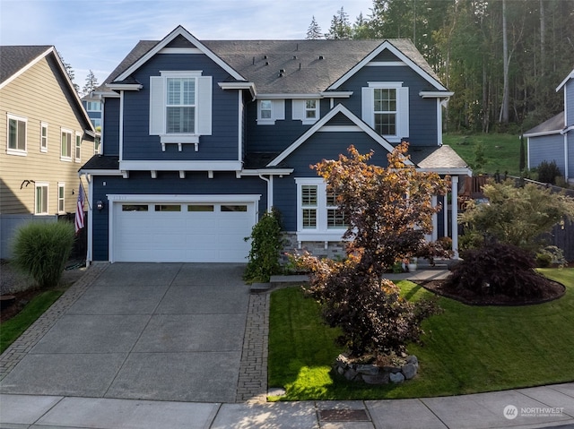 view of front of house with a garage and a front yard