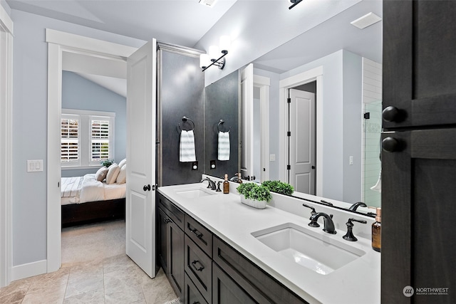 bathroom featuring tile patterned flooring, lofted ceiling, a shower with shower door, and vanity