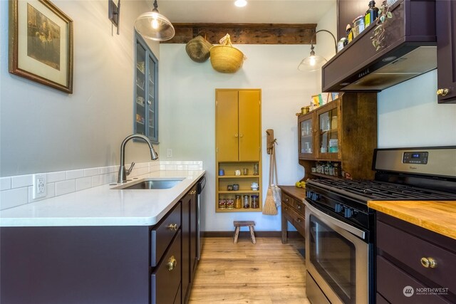 1145 School Ave, Walla Walla, WA 99362 - kitchen featuring stainless steel gas stove, a sink, light wood-style flooring, glass insert cabinets, and under cabinet range hood