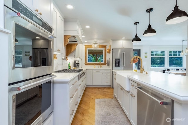 1145 School Ave, Walla Walla, WA 99362 - kitchen featuring appliances with stainless steel finishes, a sink, white cabinets, a kitchen island with sink, and recessed lighting