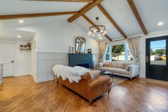 1145 School Ave, Walla Walla, WA 99362 - living room featuring beam ceiling, light wood finished floors, a brick fireplace, recessed lighting, and a decorative wall