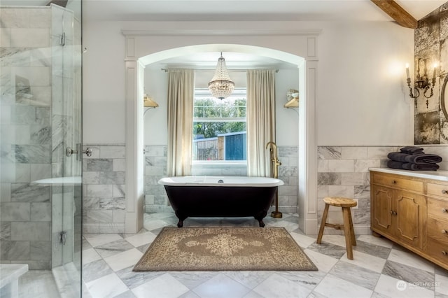 1145 School Ave, Walla Walla, WA 99362 - full bathroom with tile walls, a chandelier, a freestanding bath, a shower stall, and wainscoting