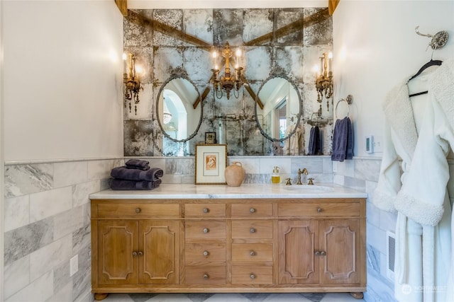 1145 School Ave, Walla Walla, WA 99362 - bathroom featuring tile walls, a chandelier, vanity, and wainscoting