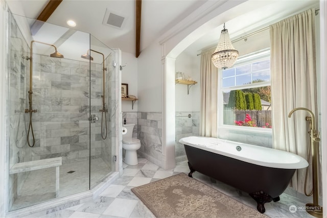 1145 School Ave, Walla Walla, WA 99362 - full bathroom with a chandelier, a soaking tub, a stall shower, tile walls, and toilet
