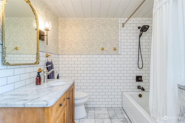 1145 School Ave, Walla Walla, WA 99362 - bathroom with vanity, toilet, shower / tub combo, tile walls, and wainscoting