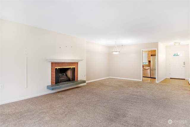 unfurnished living room with a brick fireplace and light colored carpet