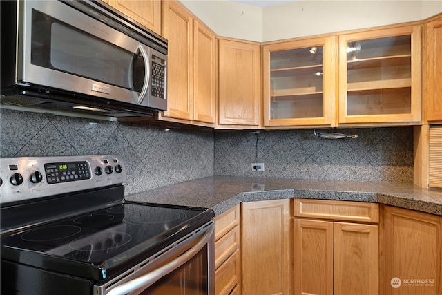 kitchen with appliances with stainless steel finishes and decorative backsplash